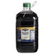 A large black jug of balsamic vinegar with a label.
