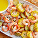 A bowl of Zatarain's liquid shrimp boil with shrimp and corn on the cob.