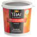 A container of THAI Kitchen red curry paste.