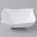 A white square bowl with a curved edge.