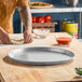 An 18-inch round aluminum deep dish pizza pan with a 1-inch rim, designed for baking pizzas.