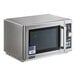 A silver Amana commercial microwave with a flag sticker.