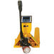 A yellow Wesco pallet truck with a Mettler Toledo scale indicator on the handle.