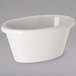 A white oval Carlisle ramekin on a gray surface.