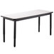A white National Public Seating utility table with a whiteboard top and black legs.