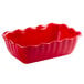 A red rectangular deli crock with scalloped edges.
