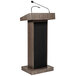 An Oklahoma Sound Ribbonwood lectern with a wireless microphone.