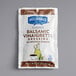 A white and brown Hellmann's Balsamic Vinaigrette dressing packet.