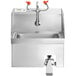 A stainless steel Regency wall mounted hand sink with knee-operated faucets and side splashes.