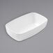 An American Metalcraft white rectangular melamine bowl on a gray surface.