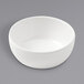 An American Metalcraft white melamine bowl on a gray surface.