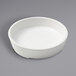 An American Metalcraft white melamine bowl on a gray surface.