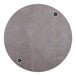 A BFM Seating Midtown round textured concrete table top with wireless charger holes.