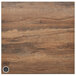A wood surface with a metal circular charging panel in the middle.