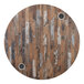 A BFM Seating Midtown round wooden table with two circular holes in it.