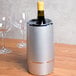 An American Metalcraft silver acrylic wine cooler with a bottle of wine inside.