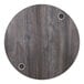 A BFM Seating round wood tabletop with two wireless charger holes.