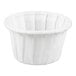 A small white paper souffle or portion cup.