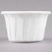 A close up of a Solo white paper souffle cup.