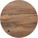 a circular wood surface with a coin