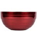 A close-up of a Dazzle Red Vollrath double wall metal bowl with a silver rim.