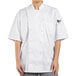 A woman wearing a white Uncommon Chef short sleeve chef coat with mesh back.