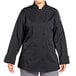 A woman wearing a black Uncommon Chef Tempest Pro Vent long sleeve chef coat.