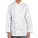 A woman wearing a Uncommon Chef white long sleeve chef coat.