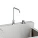 An Elkay stainless steel surgeon scrub sink with a faucet.
