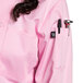 A woman in a pink Uncommon Chef long sleeve chef coat with a black pen.