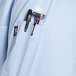 The pocket of a sky blue long sleeve chef coat with mesh back.