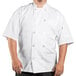 A man wearing a Uncommon Chef white short sleeve chef coat with mesh back.