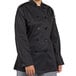 A woman wearing a black Uncommon Chef long sleeve chef coat.