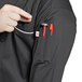 a person wearing a black shirt with a pocket full of tools