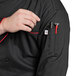a person wearing a black shirt with a pen and a stethoscope in the pocket