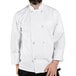 A man wearing a white Uncommon Chef long sleeve chef coat.