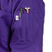 A grape short sleeve chef coat with a pocket and pen holder.