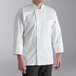 A unisex white long sleeve chef coat with a double-breasted front and a chest pocket.