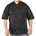 A man wearing a black Uncommon Chef Delray Pro Vent chef coat with mesh back.