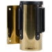 A gold and black Aarco wall-mount stanchion with a black belt.