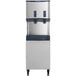 A Scotsman Meridian air cooled nugget ice machine with enclosed stand and two water dispensers.