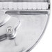 A close-up of a Waring metal julienne disc with a screw.
