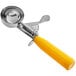 a metal scoop with a yellow handle