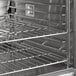 A Main Street Equipment stainless steel double deck convection oven with metal racks.