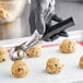 a person holding a cookie dough ball