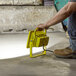 A man holding a Lind Equipment LED yellow work light.