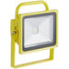 A yellow Lind Equipment LED floodlight with a grey handle.