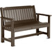 A brown wooden Sequoia garden bench with white armrests.