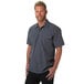 A man wearing a Mercer Culinary gray short sleeved work shirt.