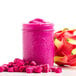 IQF organic dragon fruit pieces in a pink smoothie in a glass jar.